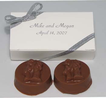 Bride and Groom Oreo Boxed - America&#8217;s favorite cookie is inserted in our "bride & groom" mold and covered in pure milk or dark chocolate.   The embossed "bride & groom" Oreo comes in a two-piece box and personalized with your choice of message.